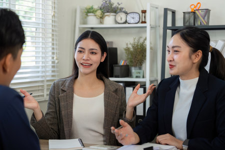 Team dynamics in financial analysis. Engaged professionals strategizing tax solutions together.の写真素材