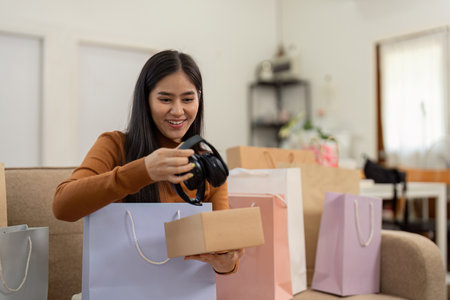 Shopping and Consumerism. Joyful woman receiving her online shopping delivery, embracing new products.の写真素材