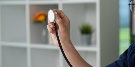 Stethoscope and Patient Monitoring. A medical student preparing to check vital signs with a...
