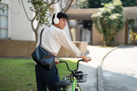 Cycling and Digital Interaction. A man enjoys the outdoors while checking his phone with his...