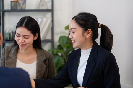 Collaboration and Business Strategy. Two professional women engaging in a discussion over a project...