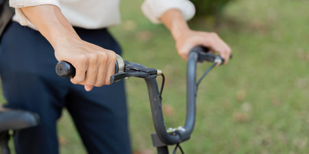 Cycling and Control. A focused individual grips the handlebars of a bicycle, ready for an adventure.の写真素材