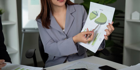 Presentation and Analysis. A professional explaining financial insights with charts.