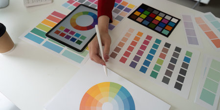 Color Selection and Digital Creation. An artists hand selects color swatches for creative projects.