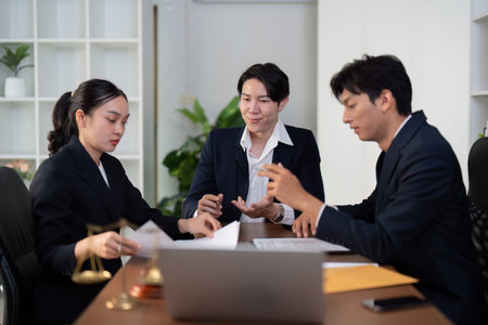 Team Collaboration and Legal Discussion. A group of attorneys working together on client cases.の写真素材