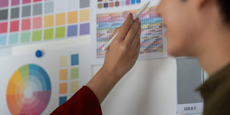 Creative Ideation and Color Selection. Team member selects colors from a comprehensive palette for a...