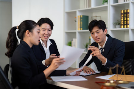 Collaboration and Legal Discussion. A team of lawyers collaborating on important case files.の写真素材