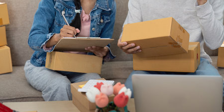 E-commerce Success and Planning. A couple working together to manage their online store and product...