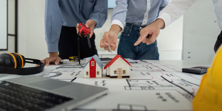 Construction Planning and Collaboration. Colleagues participating in a project meeting to design model houses.の写真素材
