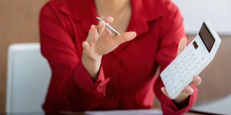 Calculating Finance Online. A professional actively engages in financial calculations while...