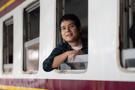 Serenity and Travel Reflections. A young man enjoying a moment at the train window, symbolizing the...