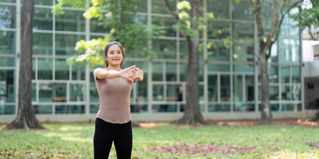 Body Care and Well-being. A woman practicing arm stretches in an outdoor environment.