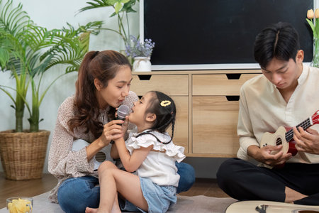 Musical Memories and Family Fun. An intimate moment between a mother and daughter during a music session.の写真素材