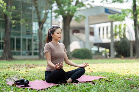 Meditation and Mental Clarity. A woman meditating in a tranquil outdoor setting.の写真素材