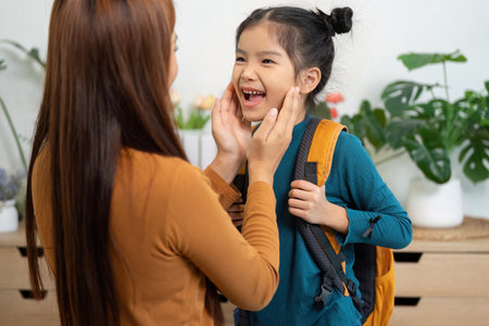 Joyful Goodbyes and Morning Love. A mother tenderly interacts with her daughter before she heads to...