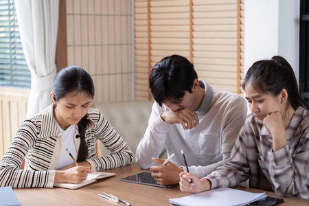 Study Group and Collaboration. Students engaged in focused study session, sharing ideas and notes.の写真素材