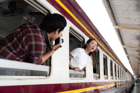 Travel and Adventure. A joyful couple capturing memories together on a train.