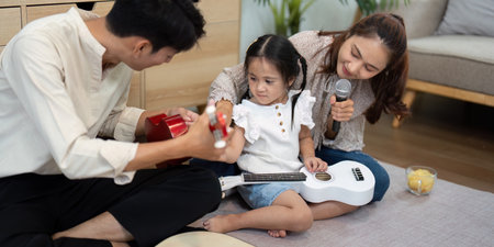 Sharing Music and Laughter. A family engaging in a fun music session.の写真素材
