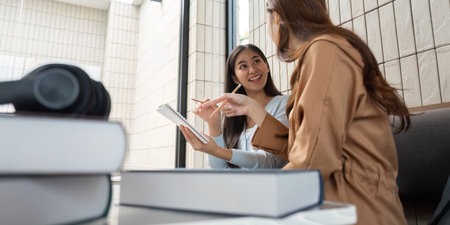 Study Partner Interaction. Engaged students collaborating effectively while sharing insights at a...