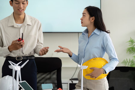 Sustainable Strategies in Team Meetings. Professionals collaborating on a sustainability project with strong communication.の写真素材