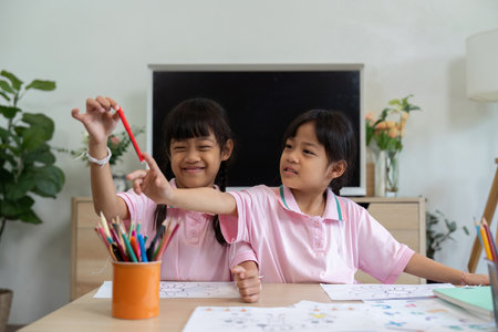 Creative Learning and Friendship. Two girls sharing art supplies while coloring together.の写真素材