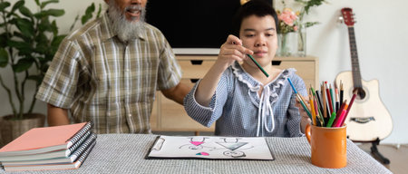 Art and Connection. A teenage girl with Down syndrome engages in drawing with her supportive...