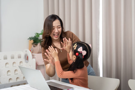 Back to School and Bonding Moments. A child and parent share a playful interaction during online...