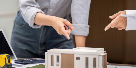 Sustainability and Architectural Design. Professionals discussing a sustainable building model.