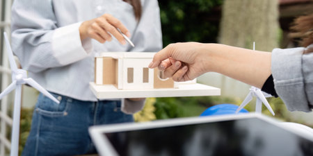 Sustainability engineer showcasing eco-friendly building concepts outdoorsの写真素材