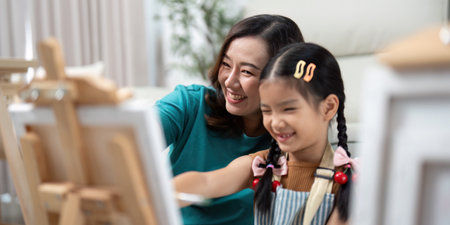 Activity mother and daughter laughing while paintingの写真素材