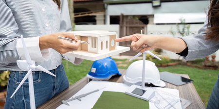 Sustainability engineer explaining building models for renewable energy