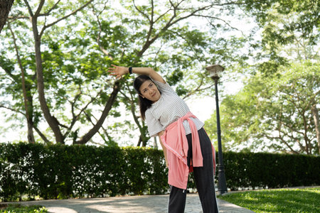 Wellness and vitality: Elderly individual engaged in side stretch outdoors