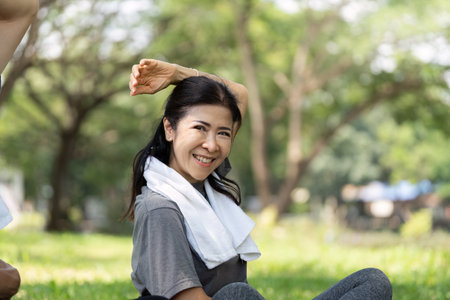 Wellness yoga practice for seniors woman stretching happily outdoorsの写真素材