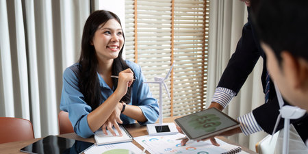 Sustainability and ESG. Smiling professional discussing ESG strategies in a collaborative office...