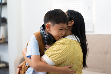 Back to School: Child Embracing Parent with Headphones Onの写真素材