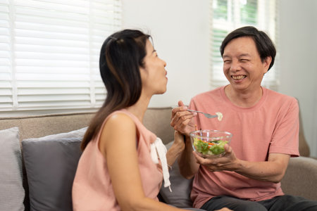 Healthy Eating and Connection. Elderly couple sharing a meal at home.の写真素材