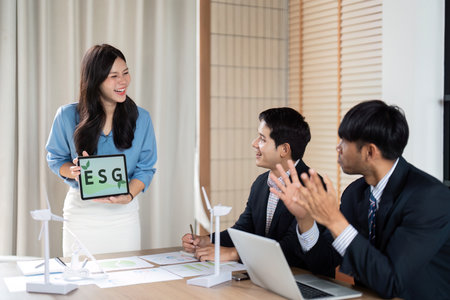ESG Engagement. Professional presenting sustainability metrics to colleagues in an interactive meeting.の写真素材