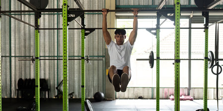 Fitness Training: Young Man Performing Muscle-Up Exercise in Gym
