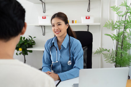 Health and Wellness. Smiling doctor consulting with a patient in a modern clinic.の写真素材