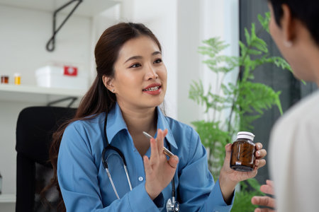 Health and Wellness. Doctor discussing medication with patient in a consultation.の写真素材