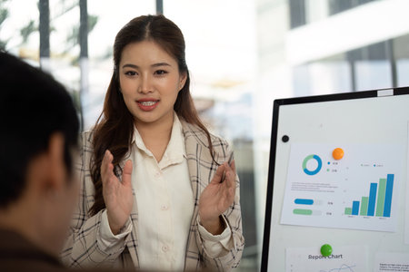 Engaging Business Discussion. Female professional explaining financial reports to a colleague.の写真素材