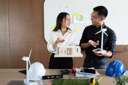 Sustainable Architecture. Engineers showcasing eco-friendly building design.の写真素材