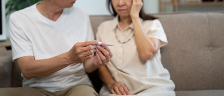 Wellness and Care. Elderly couple monitoring health together at home.の写真素材