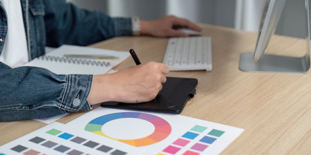 Digital Design: Professional Using Graphic Tablet for Color Palette Creationの写真素材