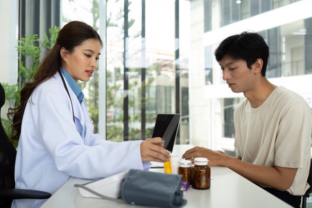 Healthcare Professional Consulting with Patient About Medicationsの写真素材