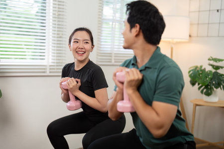 Couple enjoying a fun workout session while sharing smiles and motivation.の写真素材
