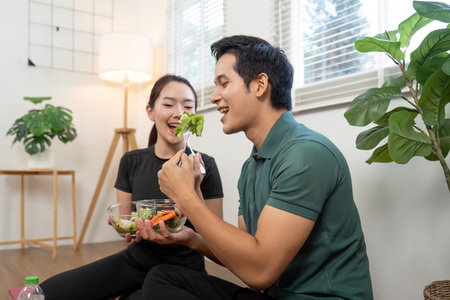 Couple Sharing Healthy Food. Two fitness enthusiasts enjoying a nutritious meal together.の写真素材
