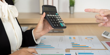 Accounting Consultation with Calculator. Business professional analyzing financial data.の写真素材