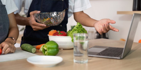 Couple Discussing Recipes. Engaging in a cooking session with fresh ingredients and technology.