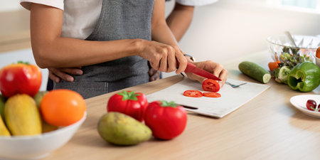 Couple Enjoying Cooking Experience. Preparing fresh ingredients together in a cozy kitchen.の写真素材